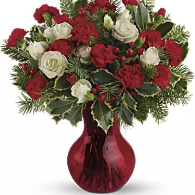 Fill your winter with joy. This sweet arrangement features white spray roses and red miniature carnations presented in our sweet red Serendipity vase.
White spray roses and red miniature carnations are accented with tips of douglas fir, holly and red berry spray.